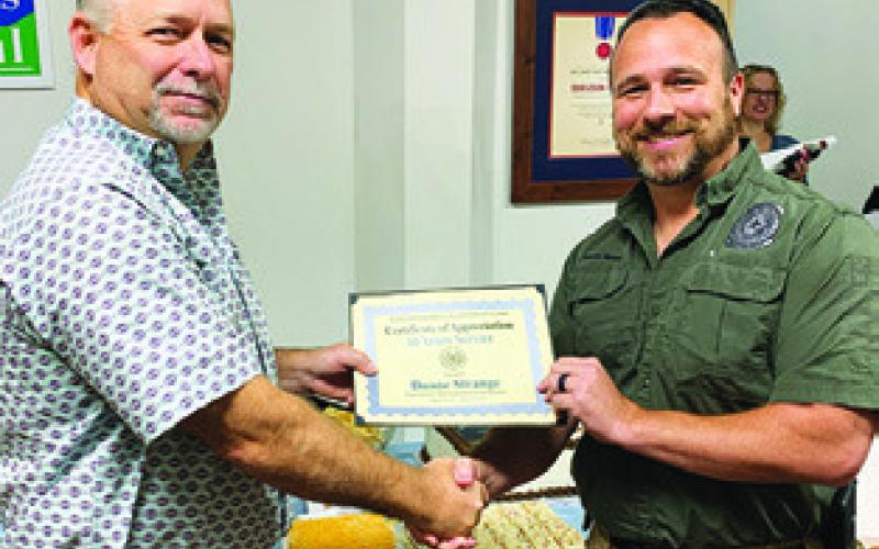 BURLESON COUNTY Judge Keith Schroeder presents this certificate of appreciation to Duane Strange on Monday.