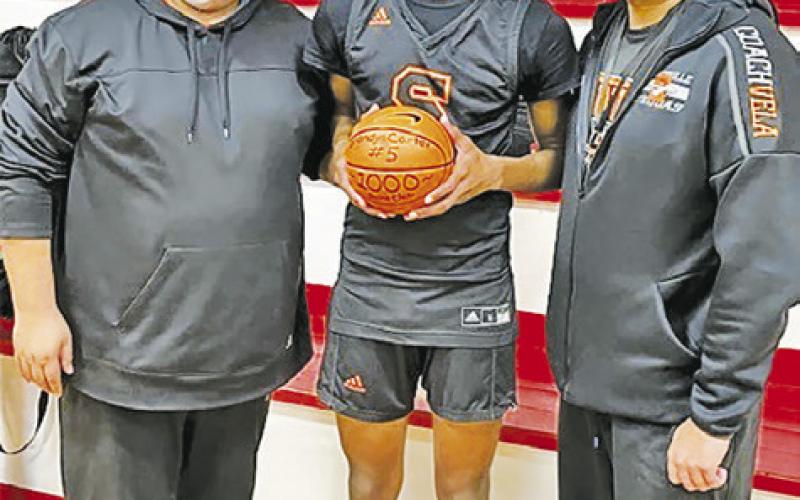 SOMERVILLE’S BRANDYN CARTER IS honored by Head Coach Rene Cantu and Assistant Coach Josh Vela at the Burton game.