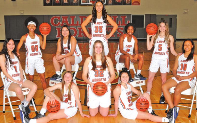 THE 2021-2022 CALDWELL HIGH SCHOOL LADY HORNET VARSITY basketball team is, from left, back, Jae Mathis, Andrea Flores, Ashlyn Kellum, middle, Sarah Segovia, Macy Narro, Daisha Denson, Ava Jones, front, Cadie Coston, Riley Broaddus and Breann Sims. -- Photo courtesy of Dianne Pursch Photography