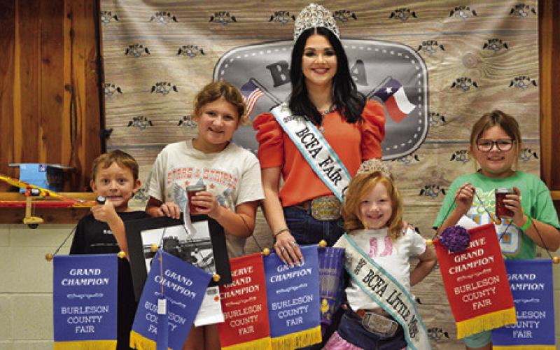 JUDE, CAROLINE AND LYNNDEE MCDERMOTT won grands in Children’s Corner Creative Arts and Crafts and Junior Creative Arts and Crafts, Canned Foods and Needlework. Also pictured are Fair Queen Kodi Hitchcock and Little Miss Taytum Hohlt. Tribune photo by Sabine Lazo