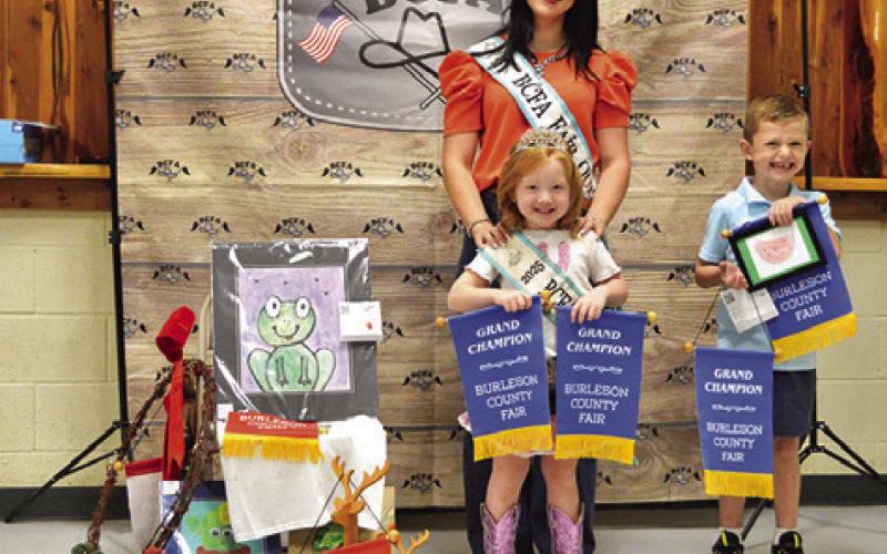 CALEB ELMORE WON GRAND IN Children’s Corner Art, Creative Arts and Crafts, and Canned Foods. Also pictured are Fair Queen Kodi Hitchcock and Little Miss Taytum Hohlt. Tribune photo by Sabine Lazo