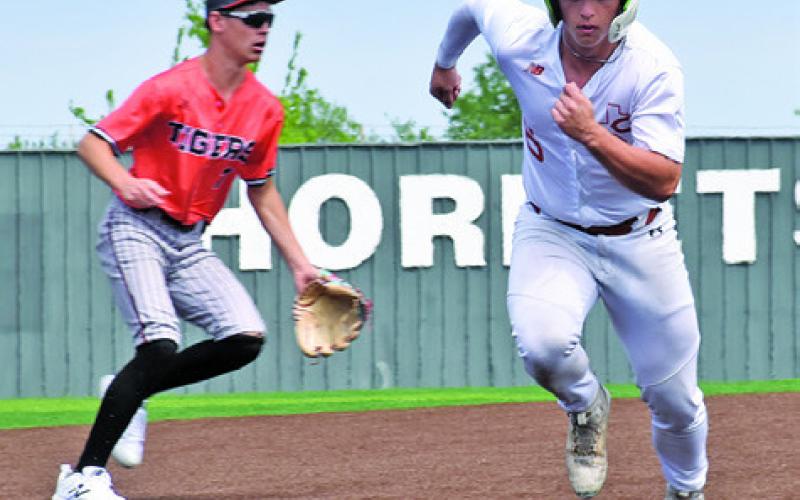 KALEB DODSON of Caldwell runs to third base against Smithville. Tribune photo by Roy Sanders