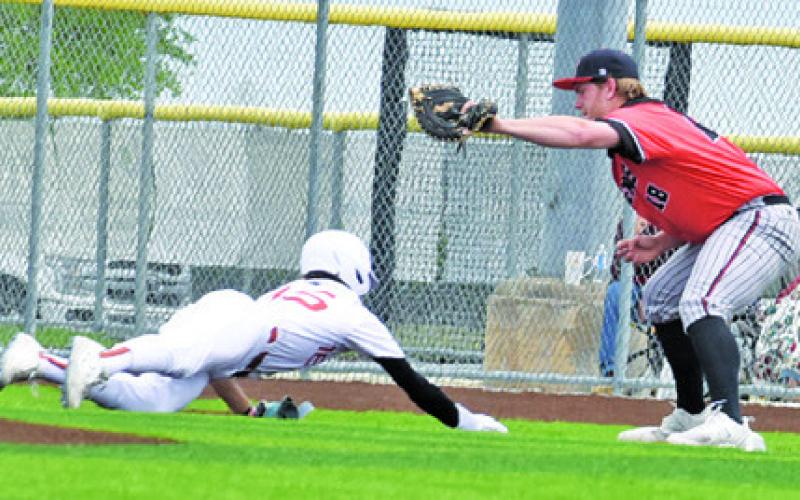 CHASE FAUST OF Caldwell hurries to get back to first base. Tribune photo by Roy Sanders