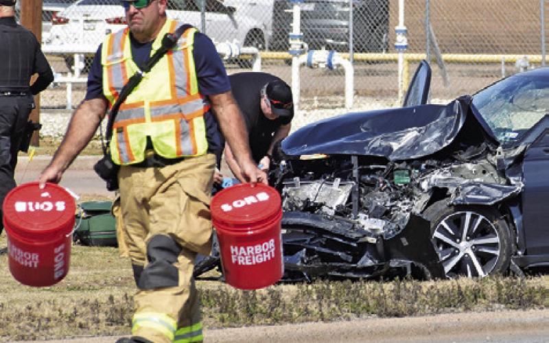 A CALDWELL FIREFIGHTER works the scene of this accident on Monday afternoon on State Highway 21 East in Caldwell. Details on the accident were not available at press time. Tribune photo by Roy Sanders