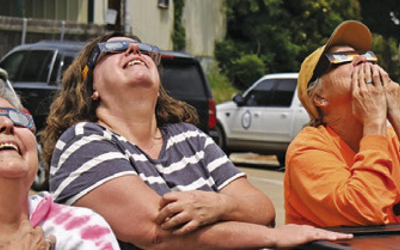 RESIDENTS ENJOY THE solar eclipse on Monday afternoon, April 8, at the Harrie P. Woodwon Memorial Library in Caldwell.