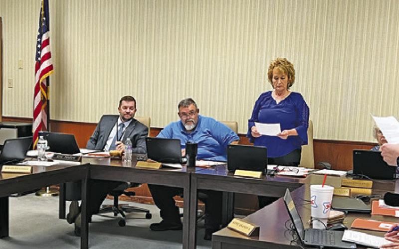 SOMERVILLE ISD’S NINFA STEVENS gives the oath of office to newly elected returning board members, David Idlebird and Melissa Tharp during last Wednesday’s board meeting.