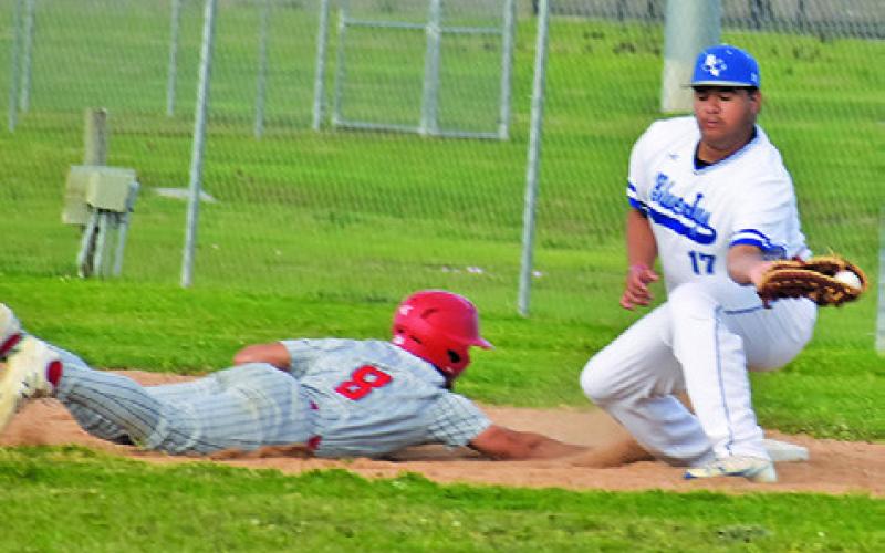 SNOOK’S RAMIRO MARTINEZ makes this catch at first base. Tribune photo by Roy Sanders