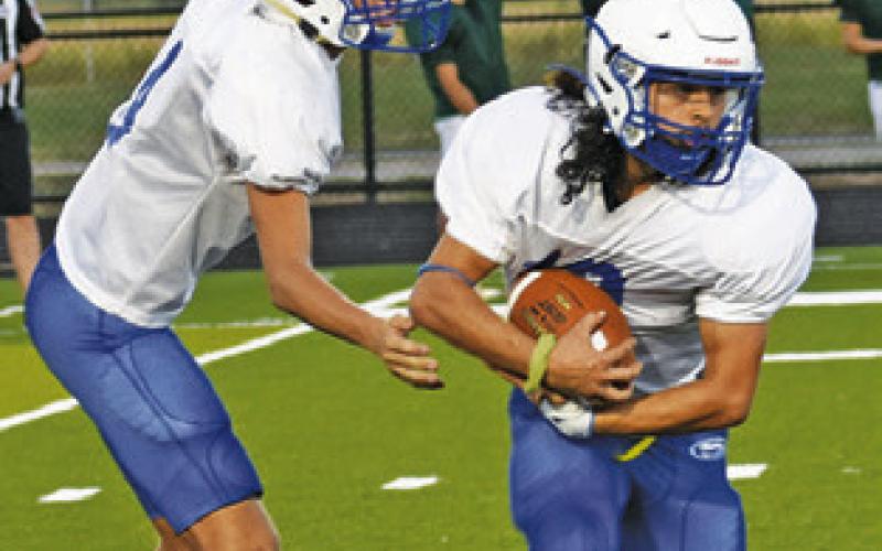 SNOOK’S BRETT Withem hands off to Tristan Yen in Snook’s scrimmage against Normangee.