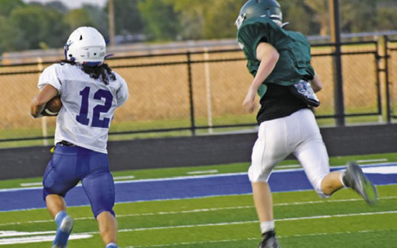 TRISTAN YEN OF Snook scores a touchdown on Friday in the Bluejays scrimmage against Normangee. -- Tribune photo by Roy Sanders