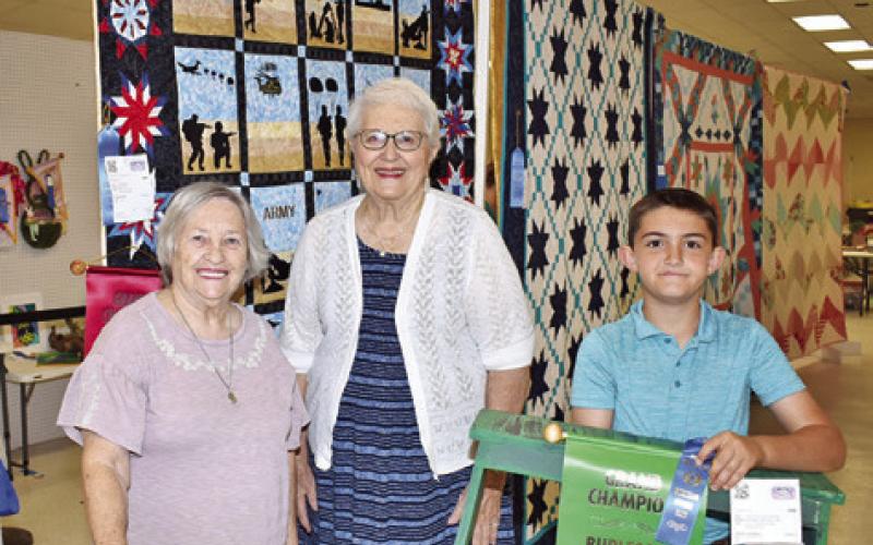 PEACHIE BURLIN WON grand champion for a small quilt, Martha Wolf for a large quilt, and Samuel Canterberry for creative arts for a step stool at the Burleson County Fair.