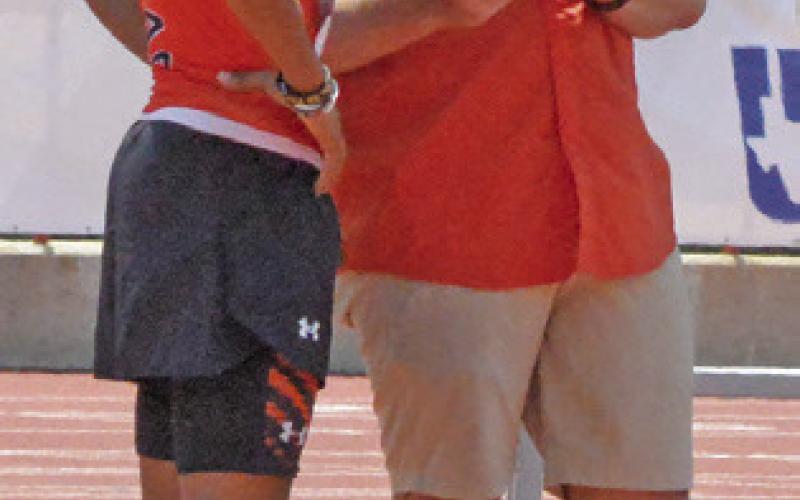 SOMERVILLE ATHLETIC Director Luke Klingler shows Jeremy Vela his previous jump in the Class 2A boys high jump on Friday during the UIL State Track &amp;amp; Field Meet. Tribune photo by Denise Squier