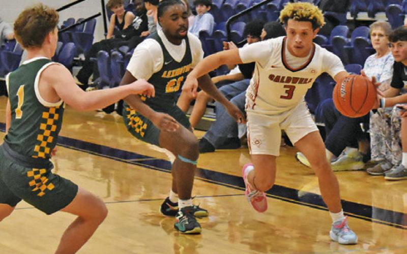 KORBIN BURNS DRIBBLES the ball in the Lexington game. Tribune photo by Roy Sanders