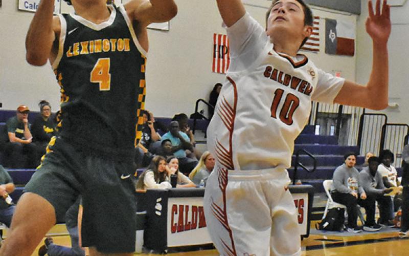 LOGAN COLBERT blocks this shot against Lexington in the Hornets’ 59-32 loss. Tribune photo by Roy Sanders