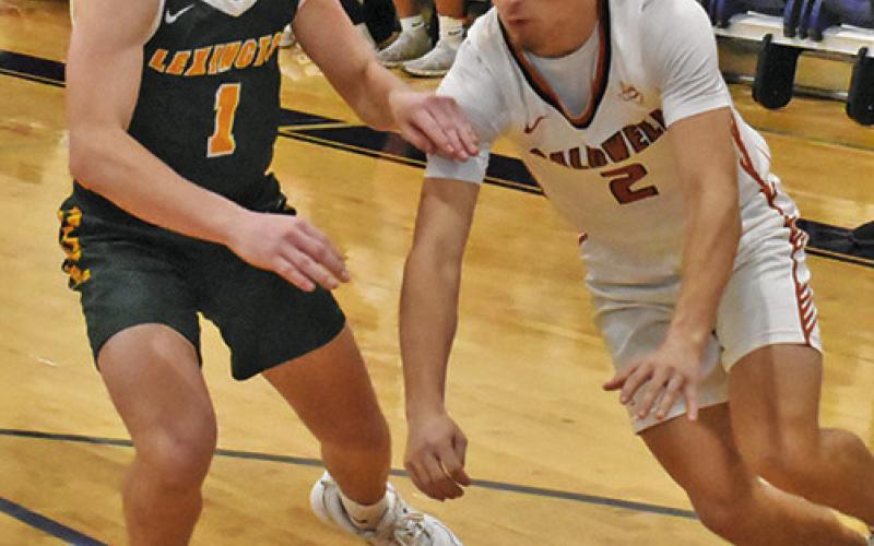 NATHAN HERMES of Caldwell dribbles the ball around this Lexington defender. Tribune photo by Roy Sanders