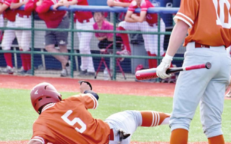 REYES SLIDES INTO home as teammate Cameron Schultz watches.