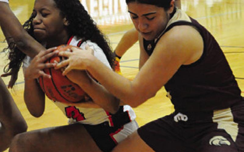 KAMRYN HARRIS wins this battle for possession against a Milano player during Friday’s game. Tribune photo by Denise Squier