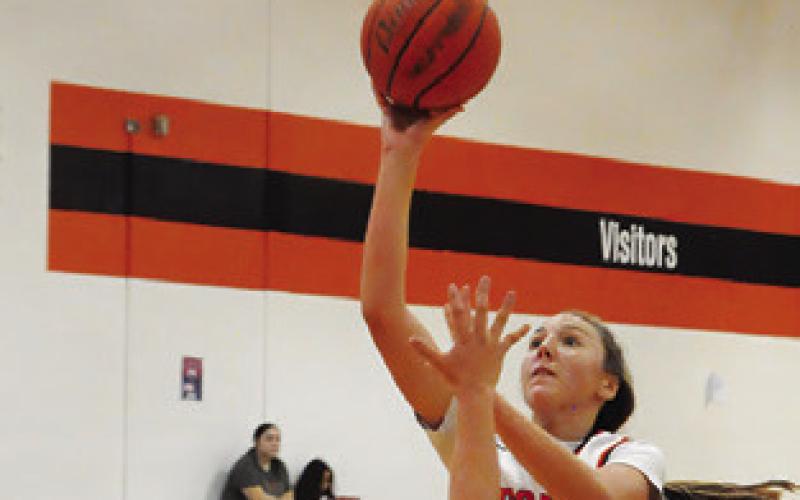 ABIGAIL RICHARDSON leaps over a Milano defender to take a shot during the Somerville win over Milano Friday afternoon. Tribune photo by Denise Squier