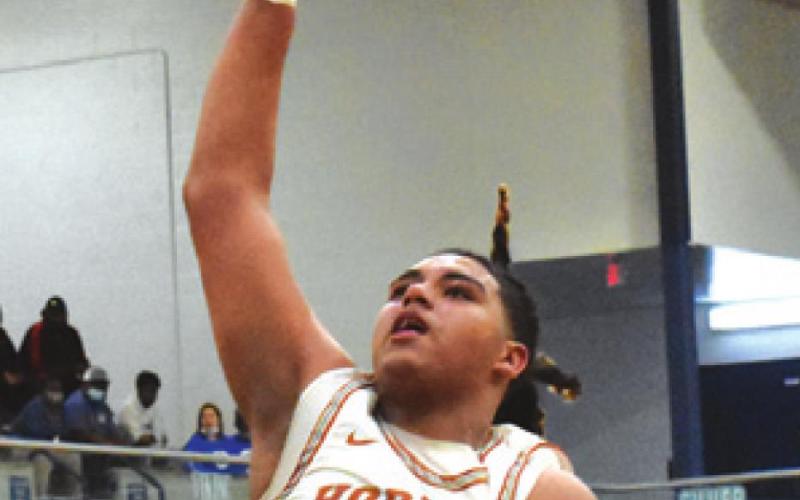 CALDWELL’S DELVIN Morris shoots the ball while Franklin’s Devyn Hidrogo looks on.