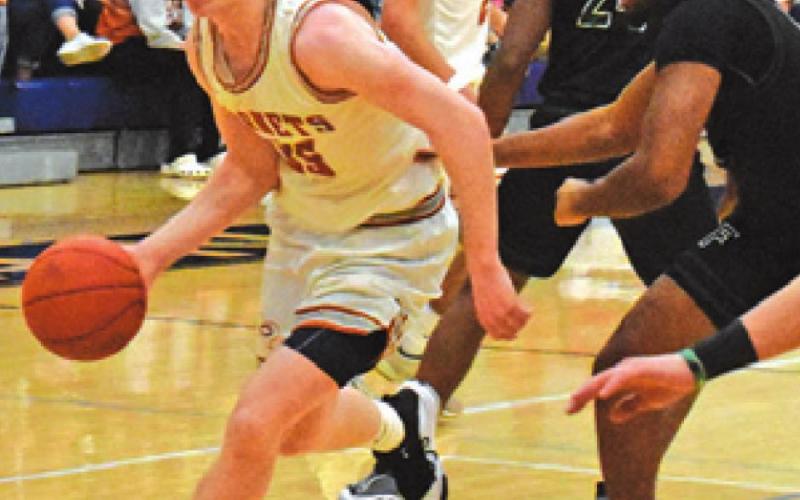 HARRISON NOVAK dribbles past Franklin defenders during Caldwell’s bi-district game last Tuesday. -- Tribune photo by Roy Sanders