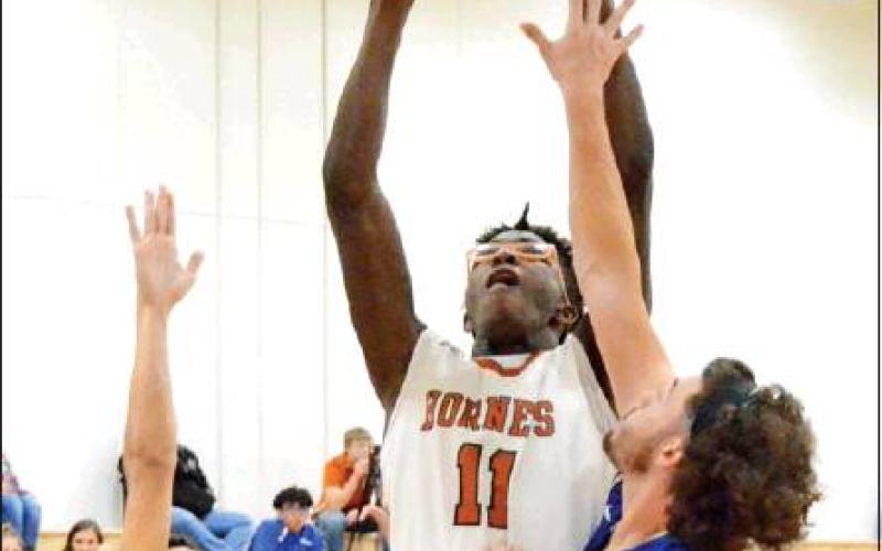 CALDWELL’S BRANDON Williams leaps high for this shot in Caldwell’s 65-48 win over Rockdale. -- Tribune photo by Roy Sanders