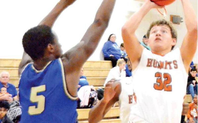 MICHAEL GONZALES of the Caldwell Hornets takes a shot last Friday against Rockdale in Caldwell. The Hornets won their opener 65-48 over the Tigers. -- Tribune photo by Roy Sanders