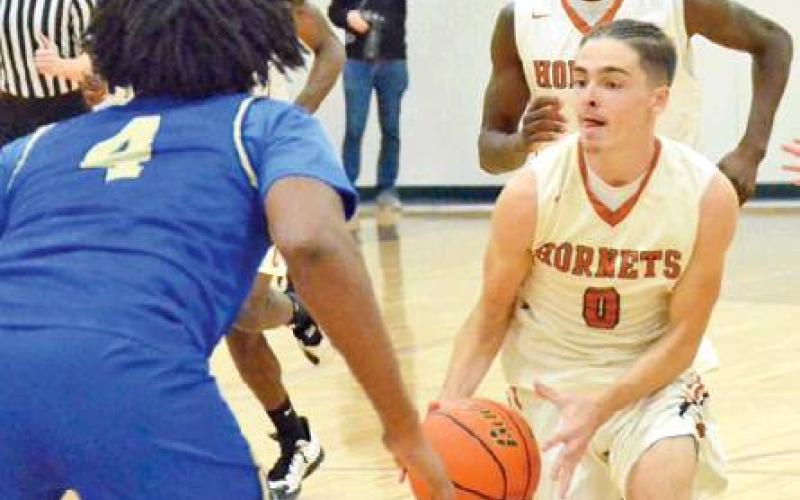 BOBBY LAROUAX dribbles the ball down the court for Caldwell last Friday against Rockdale. The Hornets won their season opener 65-48 in Caldwell. -- Tribune photo by Roy Sanders