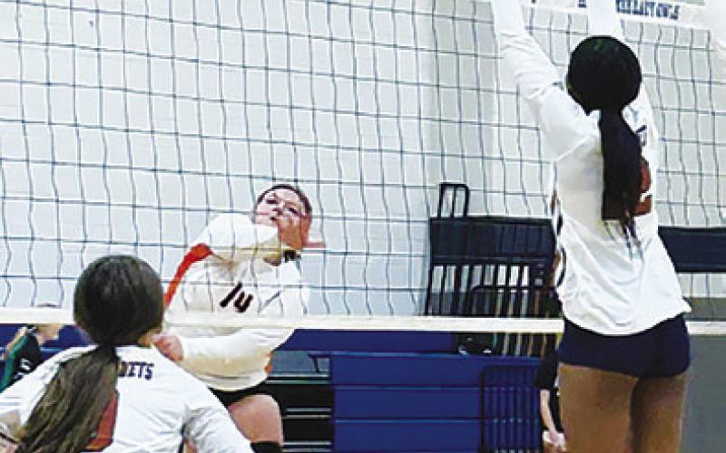 SOMEVILLE’S AUBREY KOVASOVIC hits the ball over the net while Caldwell’s Tyniah Johnson jumps to block during the Caldwell-Somerville match last Saturday morning in Anderson.