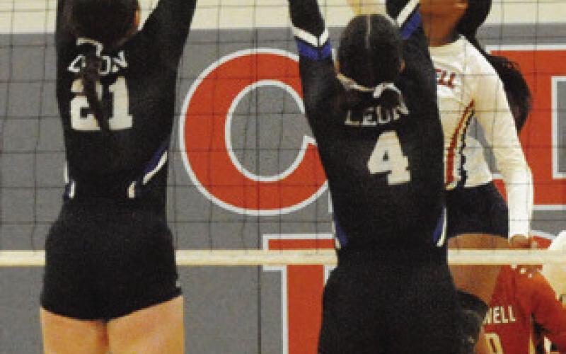 CALDWELL’S REESE MCMANUS jumps to attempt to block a hit by Leon’s Katey Cravey. Tribune photo by Denise Squier
