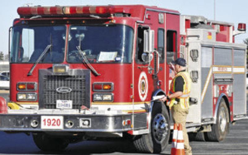 AREA FIREFIGHTERS DRIVE this course on Saturday at the Caldwell High School parking lot as part of a TEEX defensive driving course. Tribune photo by Roy Sanders