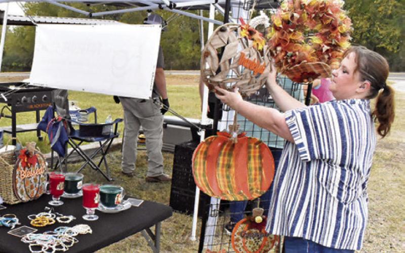 ANGIE CARPENTER OF Angie’s Assortments arranges these displays on Saturday, Nov. 15, at the Yellow Prairie Market in Chriesman.