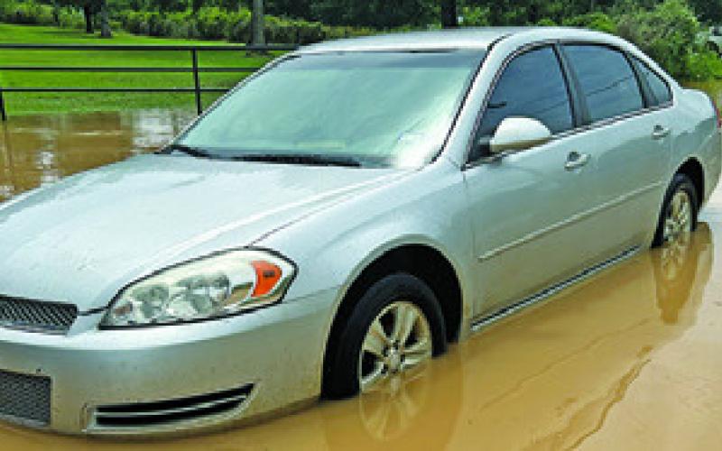 THIS CAR STALLED while crossing flood water near Cade Lakes on Monday.