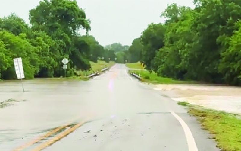 FLOODWATER CROSSED over F.M. 1362 at County Road 224 on Monday due to the heavy rain the county received overnight on Sunday.