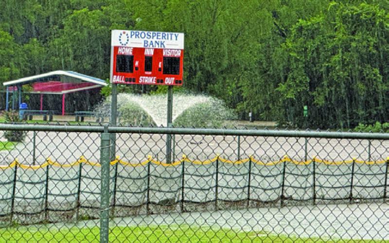 THE SOFTBALL FIELDS AT John E. Hejl Park at Davidson Creek were under water after the recent storm which brought up to a foot of rain in areas of Burleson County. Tribune photo by Denise Squier