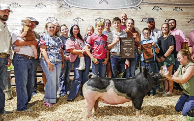 CADEN SIMON EXHIBITED the Reserve Champion Swine at the 2025 Burleson County Fair. Also pictured are Trent Williams, Darrell Kieke, Katie Williams, Linda Lee, Charlotte Prince, Nathan Glidewell, Amy Russell, Ryan Russell, Kailey Simon, Wyatt Russell, Coby Berger, Addie Berger, Judge Cory Raines, Trevor Williams, Burleson County Fair Queen Kodi Hitchcock and Little Miss Taytum Hohlt.