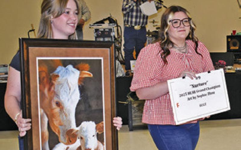 ALLISON KRUEGER and Aubrey Kovasovic display these auction items during the annual Go Texan auction on Saturday night.