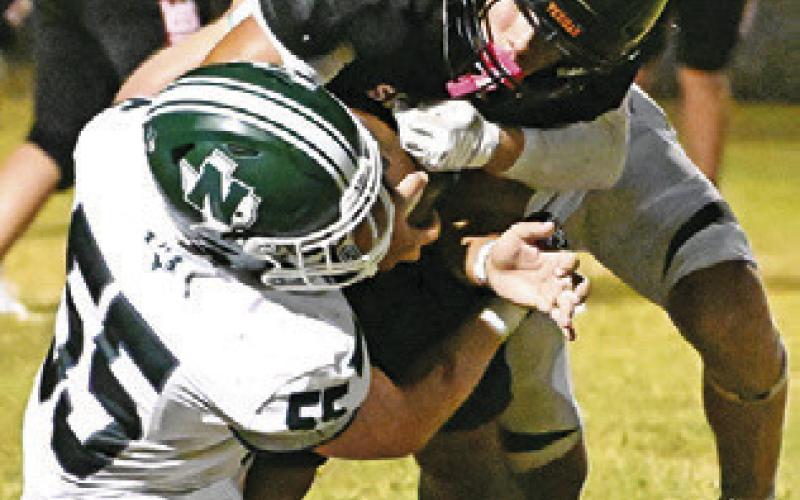 A SOMERVILLE Yegua is tackled last Friday against Normangee. The Yeguas lost their opener 35-16 in Somerville. Tribune photo by Denise Squier