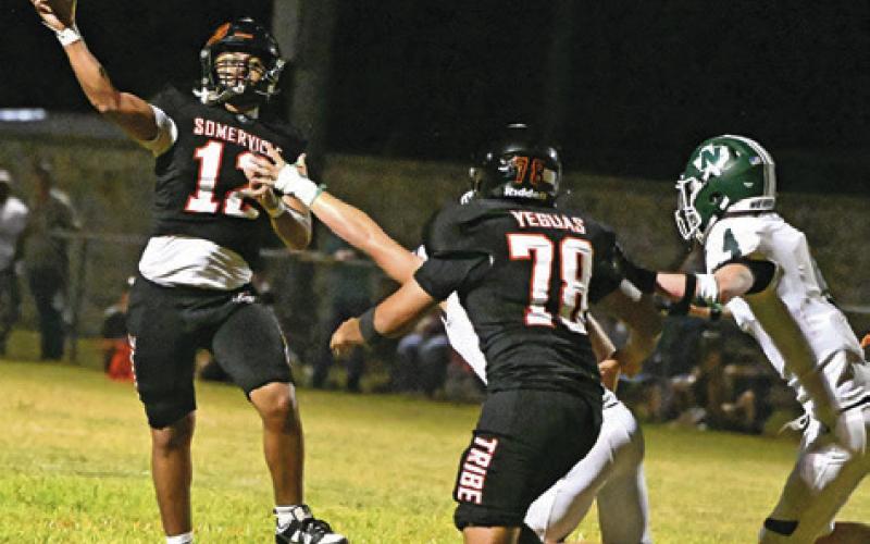 SOMERVILLE QUARTERBACK ANDY Espinoza passes last Friday against Normangee. Also pictured is lineman Angel Garcia. Tribune photo by Denise Squier