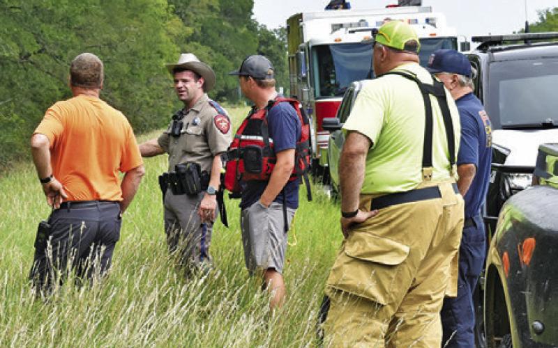 CALDWELL VOLUNTEER FIREFIGHTERS and the DPS respond to the accident scene off State Highway 36, south of Caldwell.