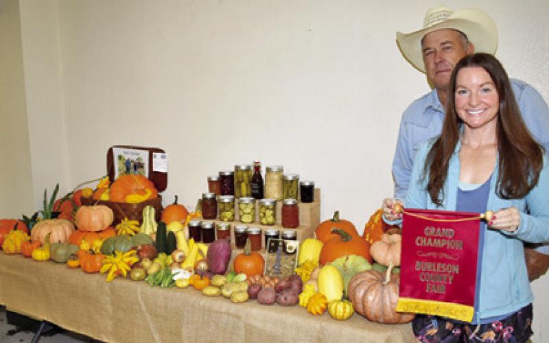 B.J. AND NICOLE Hejl display the grand champion “Hejl’s Garden” exhibit in the creative living division of the Burleson County Fair.