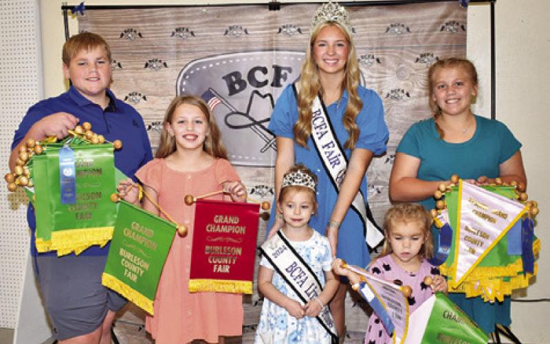 EMERSON McALLISTER WON grand champion at the Burleson County Fair for a quilt and a doll, along with Bailen and Marley Kocurek, for photos, clothing, crafts and horticulture, and Lynnlee Kocurek for grand succulents-children’s corner. Joining them are Fair Queen Hadleigh Novosad and Little Miss Avery Grace Freeman.