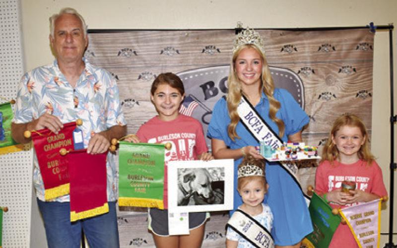 JACK WINTERROWD WON grand champion for floral arrangement and for container plant, Carson Evers for photography, and Kallie Markert for diced peaches. Also pictured are Burleson County Fair Queen Hadleigh Novosad and Little Miss Avery Grace Freeman.