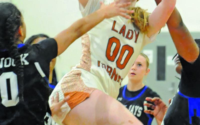 IRELAND MORGAN is fouled by Jai’Nylah Curry during the Caldwell-Snook game last Thursday. Also pictured is Jaci’lee Perez. Tribune photo by Denise Squier