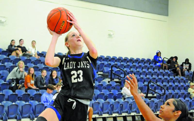 SNOOK’S DAKOTA KIENOW shoots a layup over Caldwell’s Avelynn O’Riley during the Caldwell-Snook game last Tuesday afternoon at Hornet Gym. Tribune photo by Denise Squier