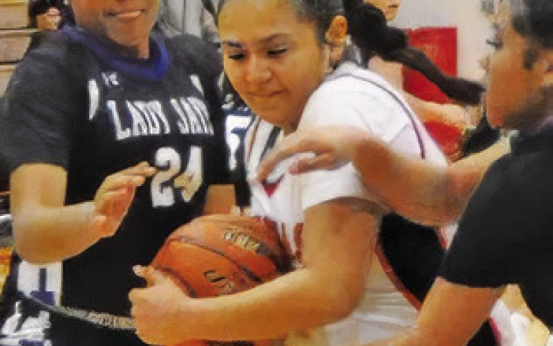 SOMERVILLE’S VIVIANNA MUNOZ fights with Snook’s Romani Johnson and Alana Stringfellow for possession of the ball. Tribune photo by Denise Squier