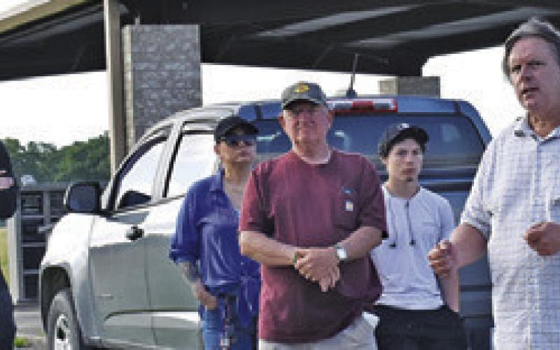 CHARLES HULME, AN Oaklawn Cemetery board member, addressing the gathering on Saturday during the cleanup effort. Also pictured are, from left, student Hunter Tuck, Athletic Director Luke Klingler, Rose Vaiz, Mr. Machemehl, Andrew Vaiz, and Carl and Ruth Cummins.