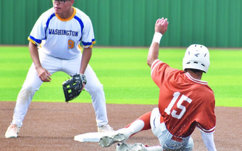 ZANE BROWN OF Caldwell slides into base against Houston Washington in the bi-district playoff. Caldwell won 11-1.