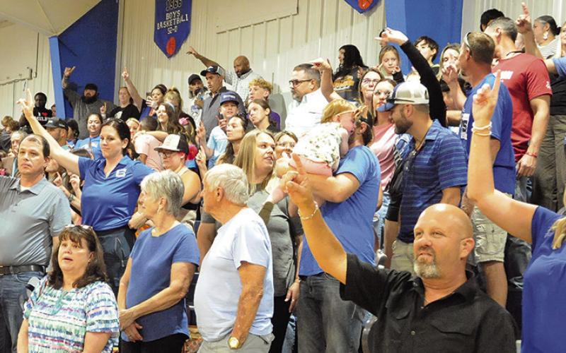 SNOOK BLUEJAY FANS IN attendance at the recent “Meet the Bluejays” showed their school spirit during the playing of the Alma Mater. Tribune photo by Denise Squier