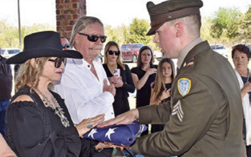 THE U.S. ARMY presents the American flag to Quincy Berka’s family members on Tuesday at his graveside service in New Tabor.