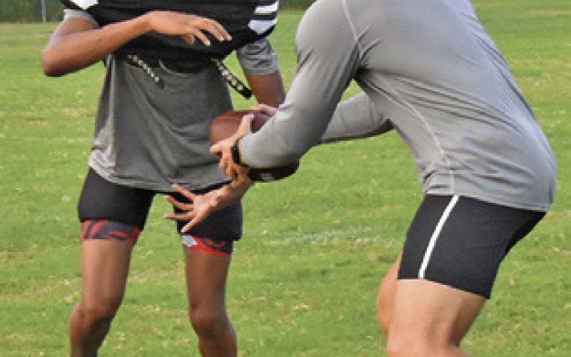 THE SOMERVILLE Yeguas work on the handoff exchange during a practice session.