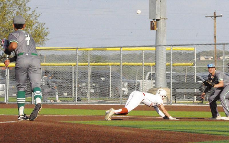 CADEN SCHLUENS OF CALDWELL dives back to first base against Banquete in a 10-0 Hornet victory last Wednesday in Caldwell. -- Tribune photo by Denise Squier